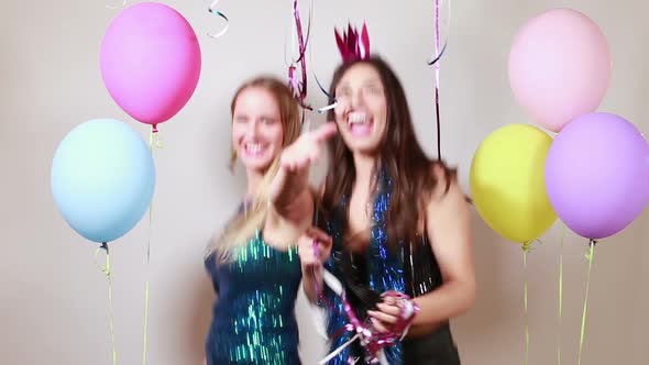 Two attractive girls dancing in photo booth