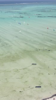 Vertical Video Kitesurfing Near the Shore of Zanzibar Tanzania