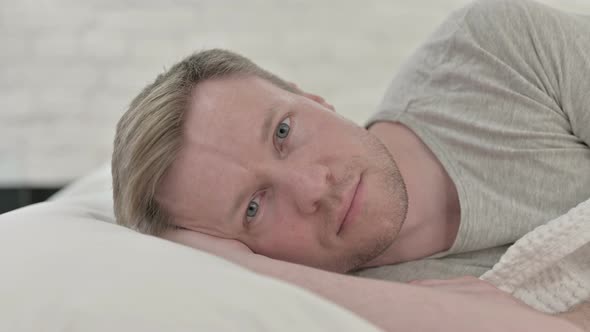 Man Thinking in Bed