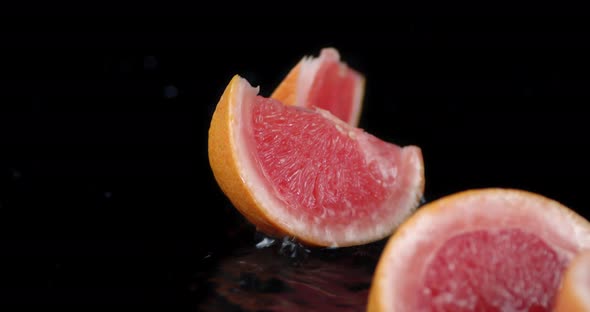 Grapefruit Pieces Fall on the Water Splashes. 