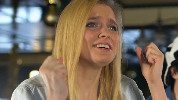 Blond Girl Crossing Fingers for Good Luck, Emotionally Supporting Favorite Team