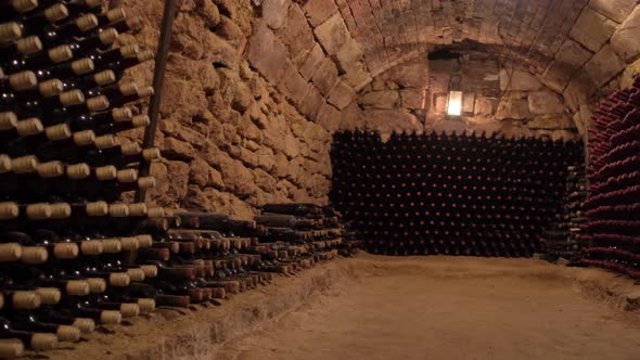 Old Wine Bottles in Rows in the Wine Cellar