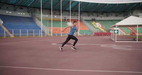 Sportsman Doing High Jump on Stadium