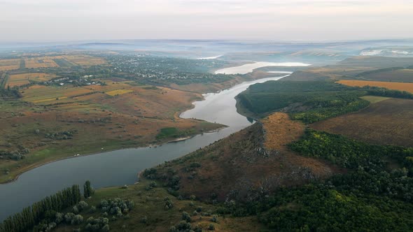 Aerial drone view of the Duruitoarea natural reservation in Moldova. River and fog in the air, hills