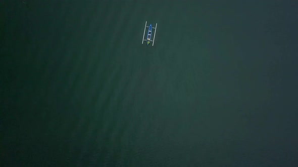 Aerial footage of traditional balinese fishing boat sailing in open sea, ocean, Bali, Indonesia