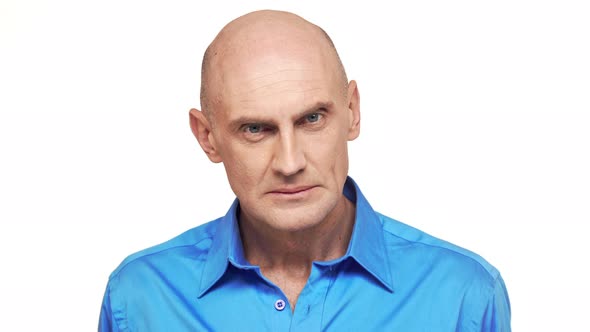 Middleaged Caucasian Male in Blue Shirt Standing at Gaze on White Background