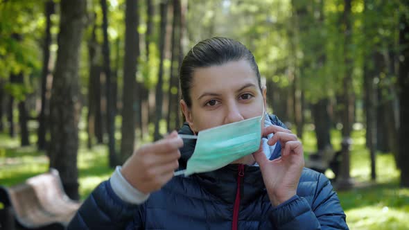 In Order Not To Get Coronavirus Infection Woman Puts Protective Mask On Her Face