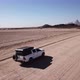 Car Driving on Gravel Road in Aerial Desert - VideoHive Item for Sale