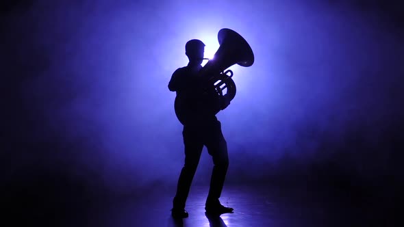 Trumpeter Man in Smoky Studio Plays on Tuba, Slow Motion