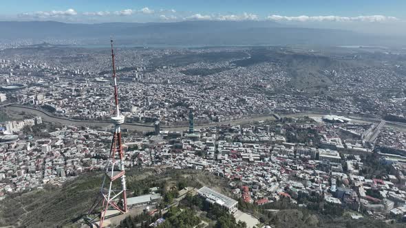 Aerial view of TV Tower in Mtatsminda park. Against the background of the city. Tbilisi, Georgia