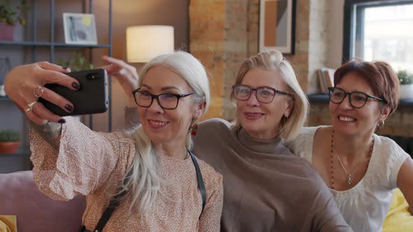 Three Mature Women Taking Selfie Portraits on Smartphone