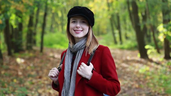 woman in coat in park.