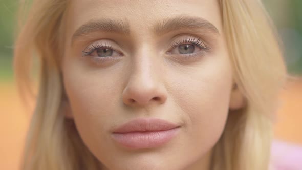 Extreme Close-up of Grey-eyed Blond Woman Looking at Camera and Smiling. Portrait of Charming Young