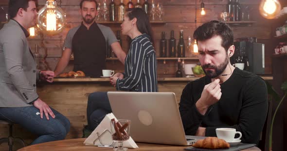 Concerned Young Man Having a Video Voice Chat with His Business Partners