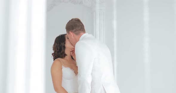 Bride and Groom Kissing Wedding Couple Indoors Looking at Each Other Beautiful Girl Model in White