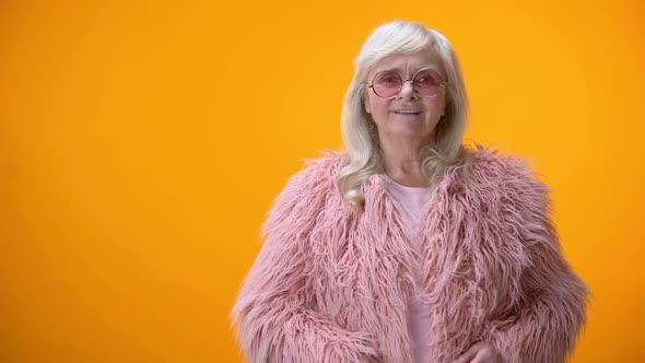 Aging Positive Lady Taking Off Glasses, Looking Directly at Camera, Scrutinizing