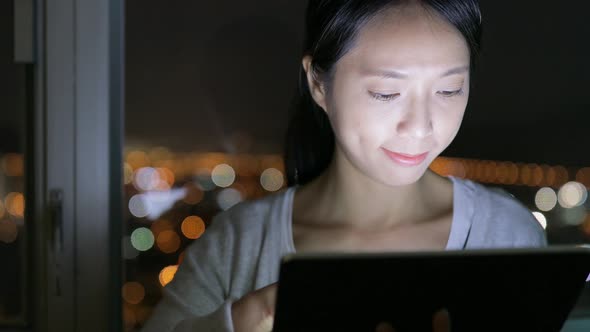 Woman browsing on digital tablet at home