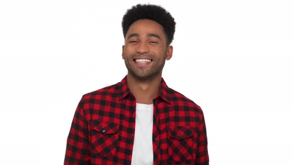 Portrait of Handsome Stubbled Afro American Guy in Red Plaid Shirt Looking on Camera Giggling Out