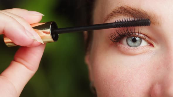 Young Woman Painting Eyelashes Using Black Mascara Halfface Portrait