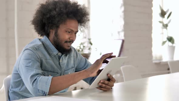 Creative African Man Browsing Internet on Tablet