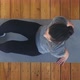 Plump Woman in Sportswear Lies Down on Mat on Wooden Floor - VideoHive Item for Sale