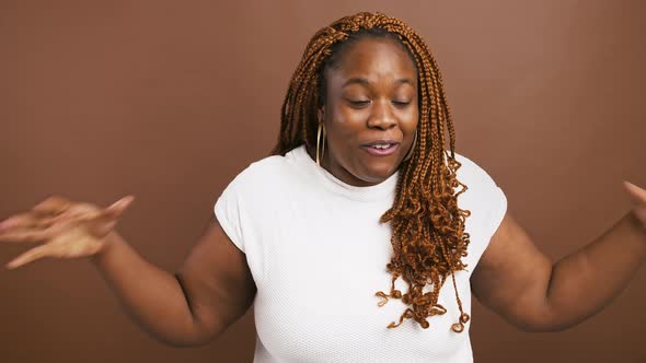Emotional African American Woman Gesturing in Shock Can't Believe Her Fortune Brown Studio