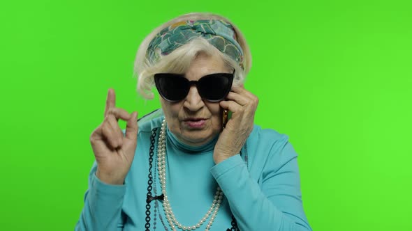 Elderly Stylish Caucasian Grandmother Woman Talking on Mobile Phone. Chroma Key