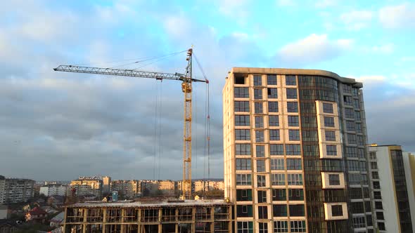 Aerial view of high residential apartment building under construction. Real estate development.