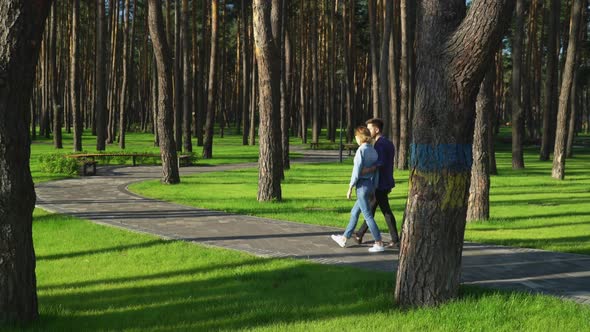 Family Going Along the Green Lawns and Pine.