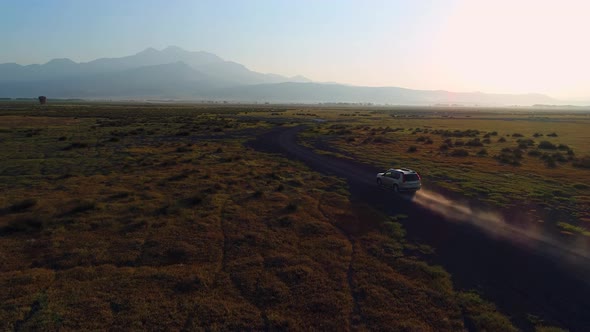 Car Driving On Dirt Road Sun