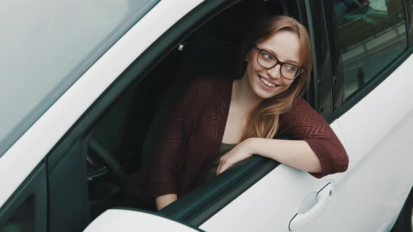 Close Up, Face Expression of Young Caucasian Woman Sitting on the Driver Seat and Looking Through