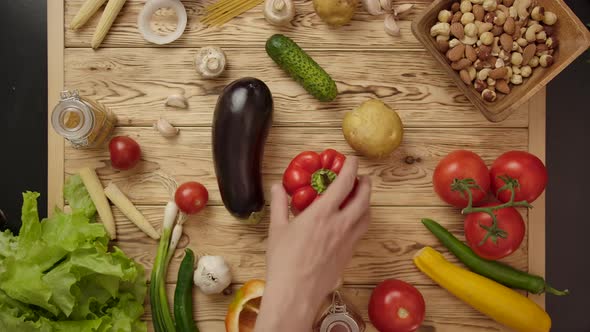 People Taking One By One Vegetables From Table