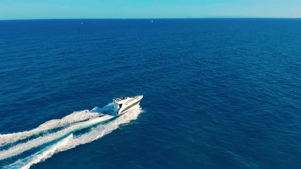 Aerial View. Boat Moves on the Sea. One Boat in the Blue Sea. Concept Travel and Vacation.