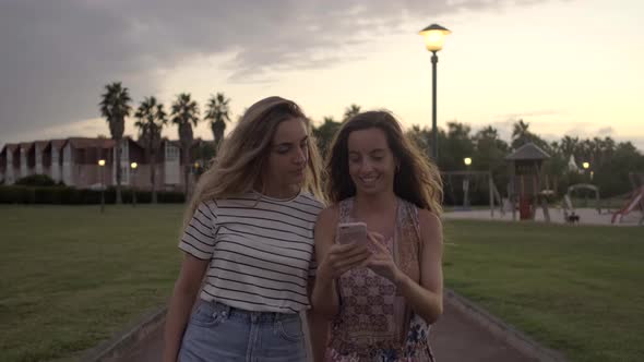 Slow motion shot of young women walking in park