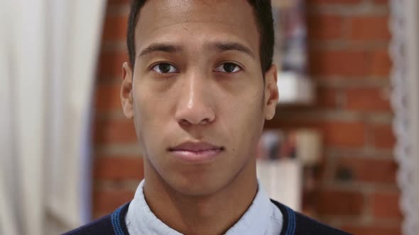 Portrait of Serious Young African Man Loft Background