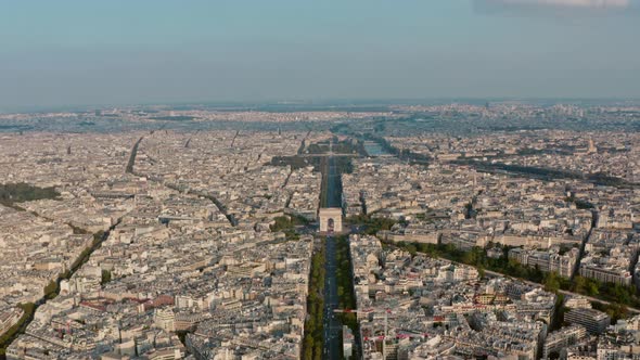 Dolly forward drone shot of the Arc de Triomphe Champs Elysees Paris golden hour sunset