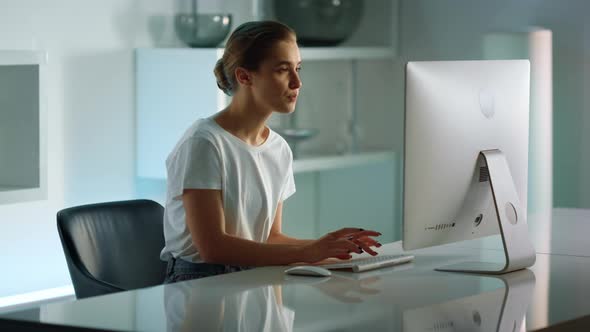 Confident Businesswoman Typing Desktop Computer