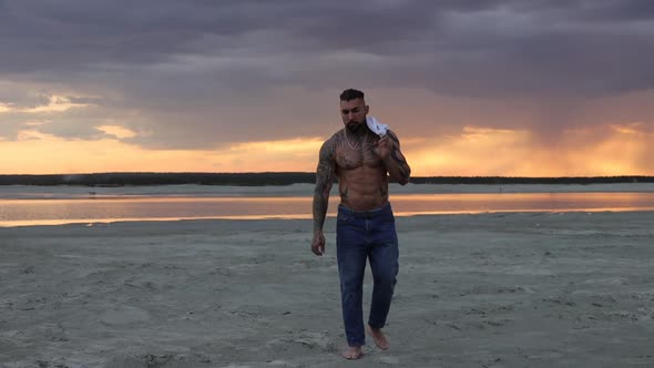 Masculine Man on Shore at Sunset