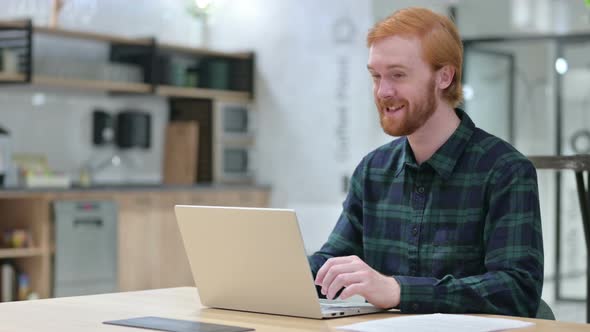 Online Video Chat on Laptop By Beard Redhead Man 