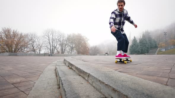 Male Skater Jumps Off the Steps and Shows a Grab in the Air