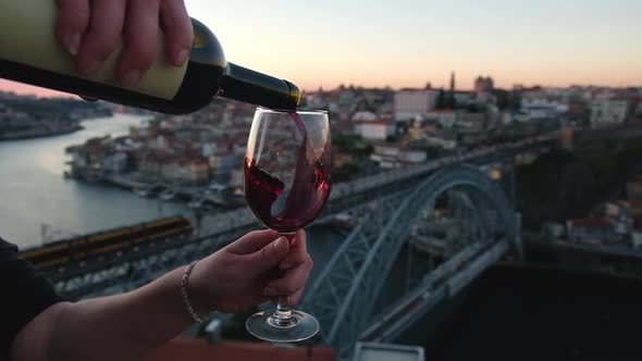 Pouring Red Wine From a Bottle Into the Glass