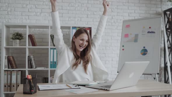 Happy Excited Successful Businesswoman Triumphing in Office