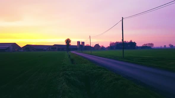 Aerial Cinematic Clip Drone Flying Over a Farm Field During Sunset