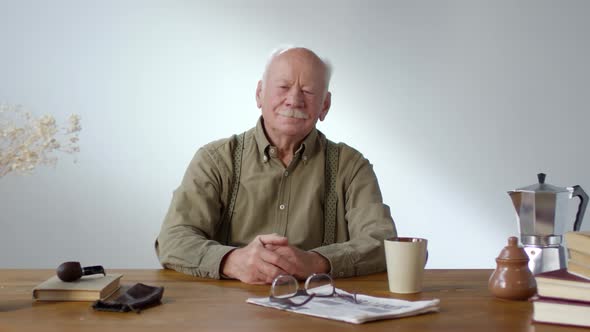 Charismatic Senior Man Sitting at Table