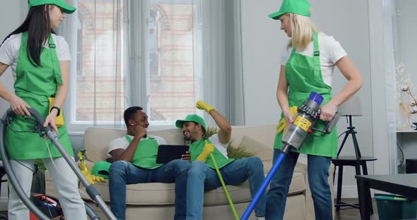 Female Cleaner are Dissatisfied that their Male Cheerful Multiracial Colleagues don't Help Them