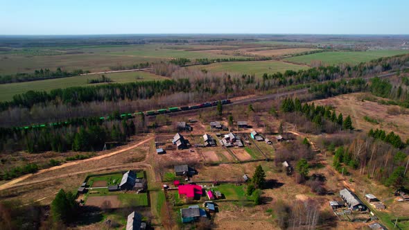 A View of the Village and a Passing Freight Train with Green Train Car Wagons