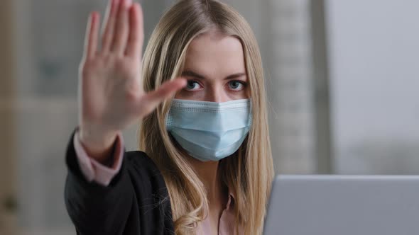 Portrait in Office Caucasian Girl Woman in Medical Face Mask with Laptop Angry Looking at Camera