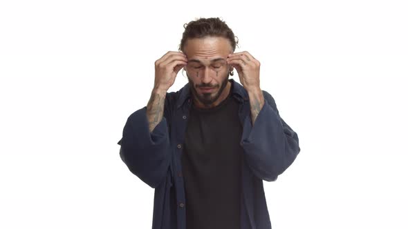 Handsome Bearded Man with Tattoos on Body and Face Showing Head Explosion Gesture Hear Mindblowing