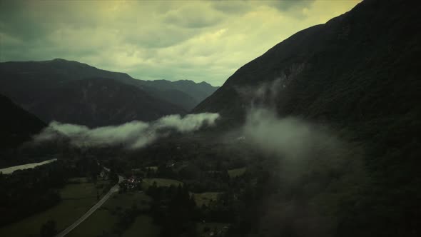 Aerial view of Soca river valley with misty clouds in full nature, Slovenia.