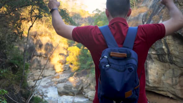 Man with Backpack Travels in Mountains